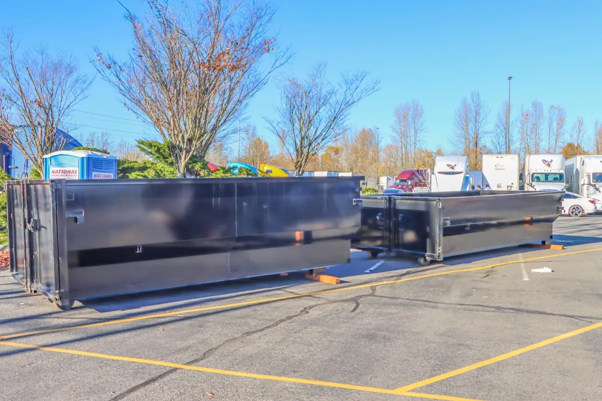 Professional dumpster rental service with roll-off container on residential driveway in Andalusia